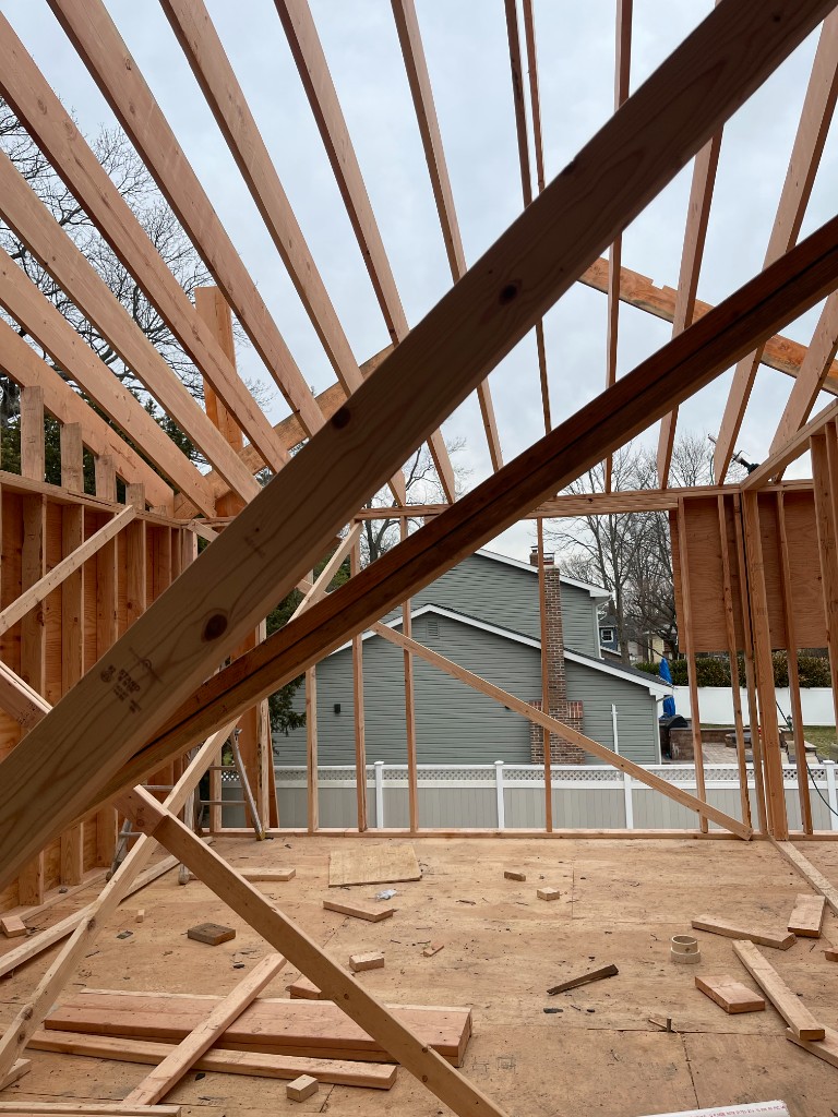 Room addition with wood framing and structural work in progress