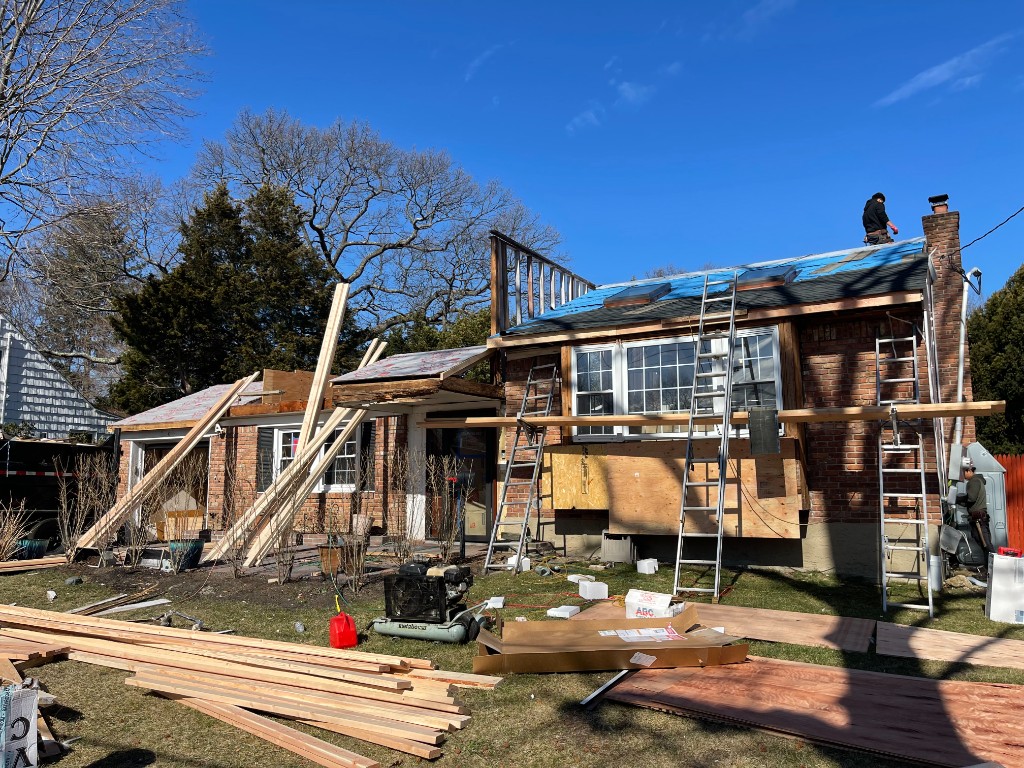 Home extension under construction: exterior framing and roofing in progress