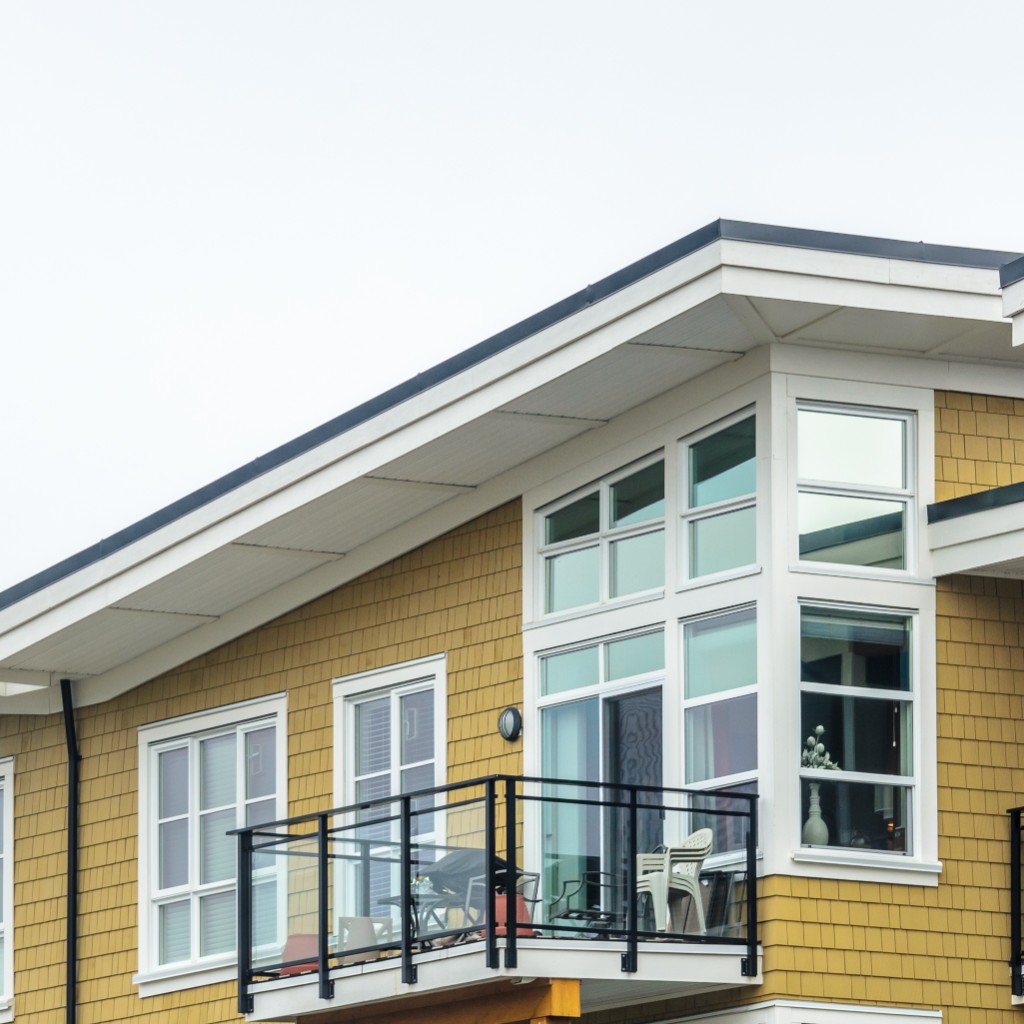 Modern home with grid windows, balcony, and sliding glass door